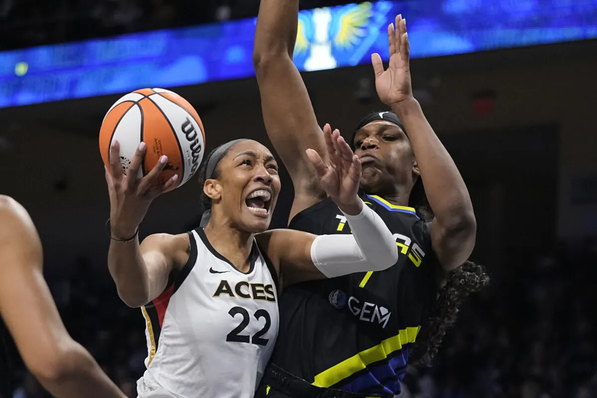 Las Vegas Aces forward A'ja Wilson (22) makes a move to the basket as Dallas Wings center Teaira McCowan defends during the first half of Game 3 of a WNBA basketball playoffs semifinal in Arlington, Texas Sept. 29, 2023. (Sam Hodde/AP Photo)
