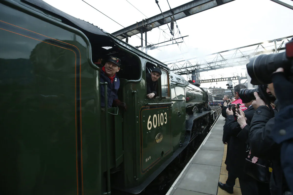 The Flying Scotsman, a historical locomotive, arrives at Kings Cross railway station in London to pick up passengers for its journey to York, on Feb. 25, 2016. (Alastair Grant/AP Photo)