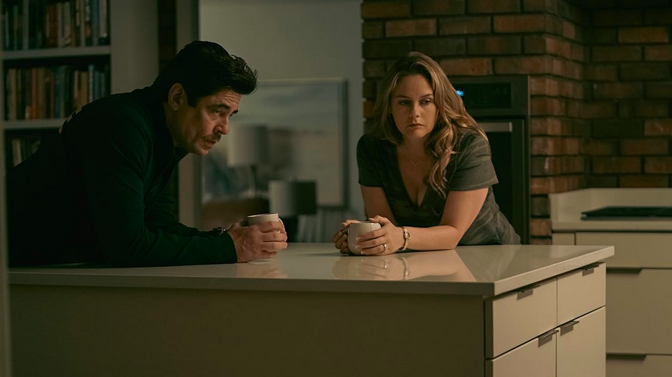 man and woman lean on table in REPTILE