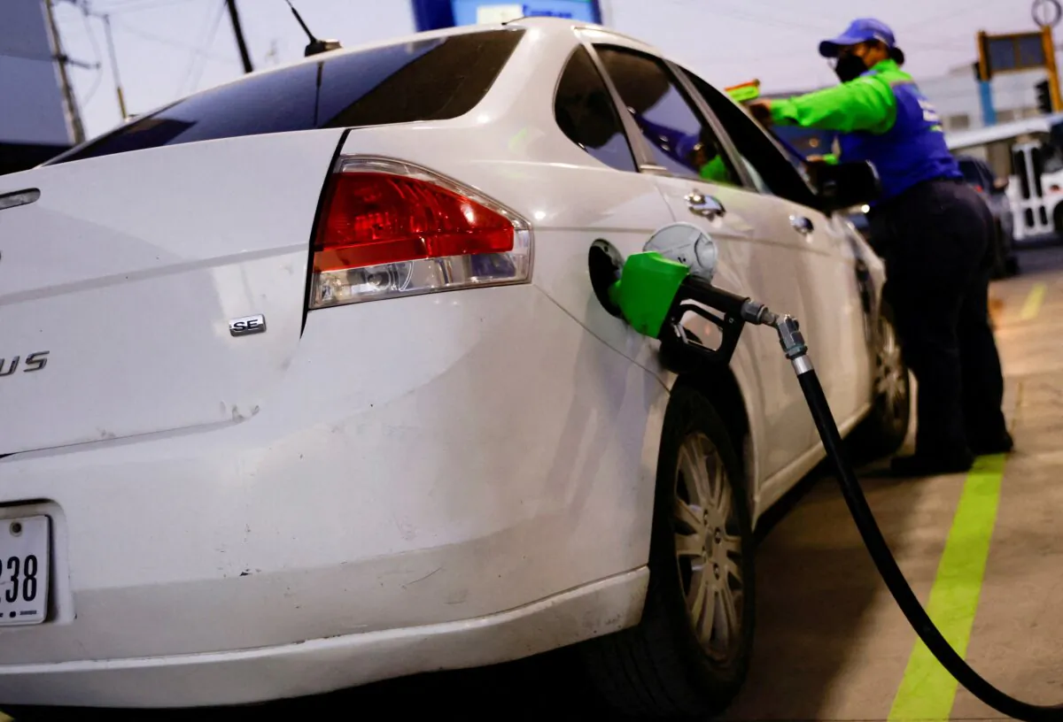 A worker fills a car belonging to a Texas resident with gasoline at a gas station in Ciudad Juarez, Mexico, on March 14, 2022. (Jose Luis Gonzalez/Reuters)