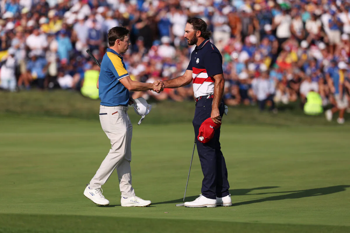 Matt Fitzpatrick of Team Europe and Max Homa of Team United States shake hands on the 18th green during the Sunday singles matches of the 2023 Ryder Cup at Marco Simone Golf Club in Rome on Oct. 1, 2023. (Richard Heathcote/Getty Images)