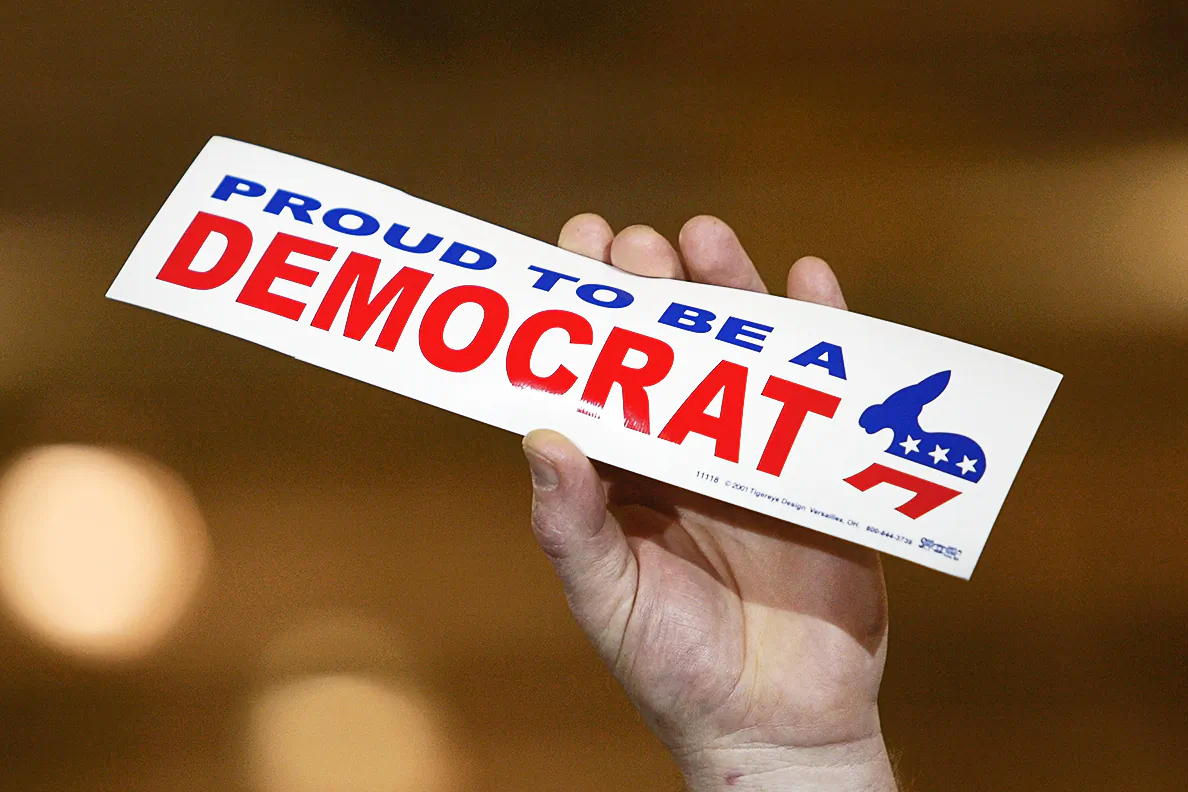 A supporter of the Democratic Party holds a bumper sticker during a rally in Warren, Mich., on Oct. 25, 2004. (Justin Sullivan/Getty Images)