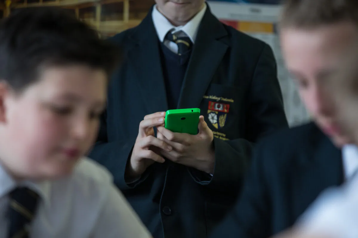 A pupil uses his mobile phone for research during an English lesson at the Ridings Federation Winterbourne International Academy in Winterbourne near Bristol, England, on Feb. 26, 2015. (Matt Cardy/Getty Images)