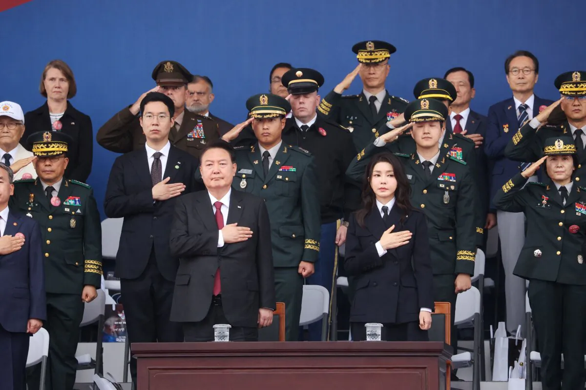 South Korean President Yoon Suk Yeol (front centre L) and his wife Kim Keon Hee (front centre R) salute the national flag during a ceremony to mark the 75th anniversary of Korea Armed Forces Day in Seongnam on Sept. 26, 2023. (Kim Hong-Ji/AFP via Getty Images)