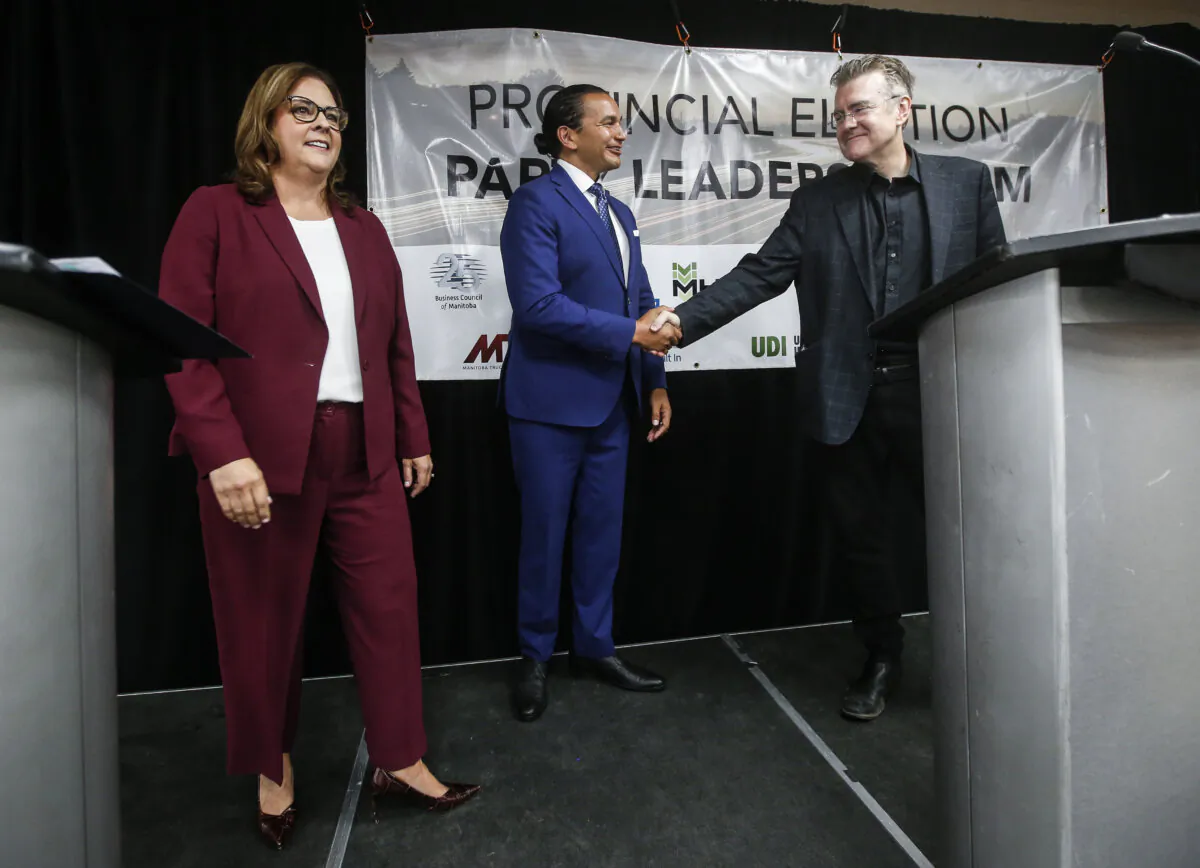 Manitoba provincial party leaders Heather Stefanson (L), a Progressive Conservative, Wab Kinew (C), a New Democrat, and Dougald Lamont, a Liberal, shake hands after the Party Leaders Forum—Growing the Economy, in Winnipeg on Sept. 12, 2023. (John Woods/The Canadian Press)