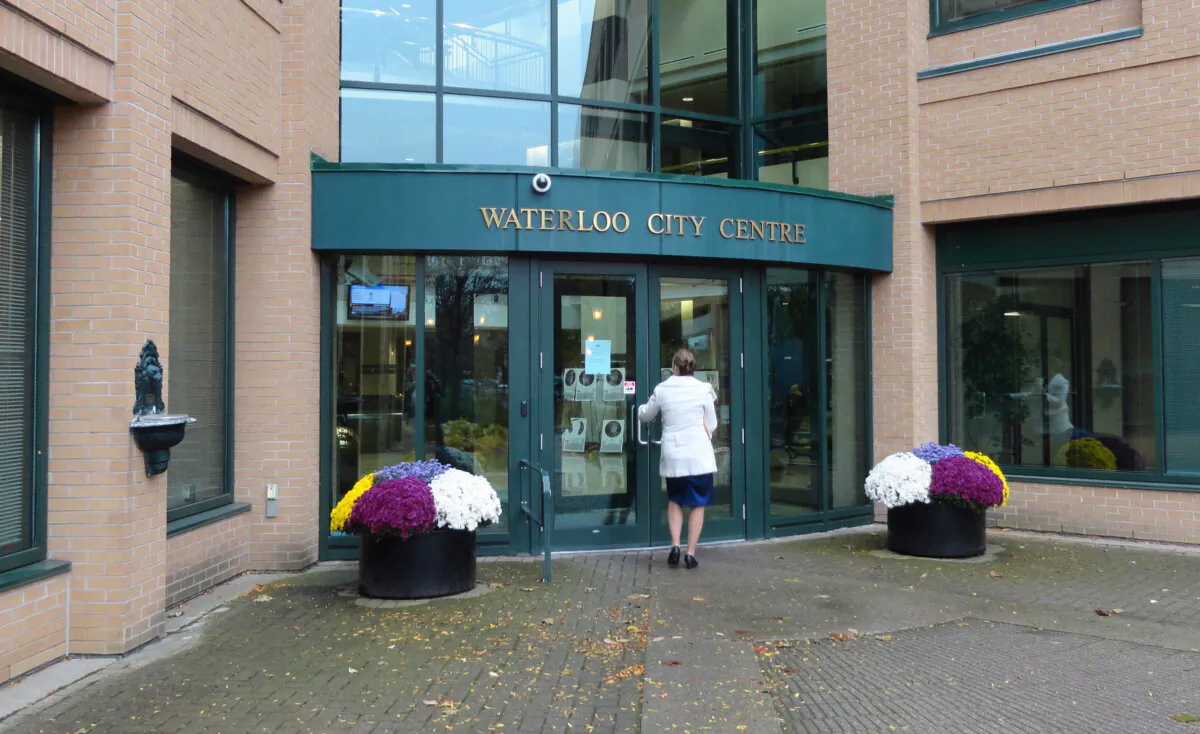 A woman walks into the Waterloo City Centre, part of the City Hall building, in a file photo. (The Canadian Press/David Friend)