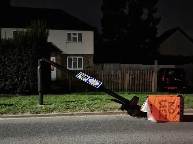 An ULEZ camera lies on the ground after being cut down in Harefield, near Uxbridge, England, on Aug. 28, 2023. (Courtesy of AJ Simpson/PA)
