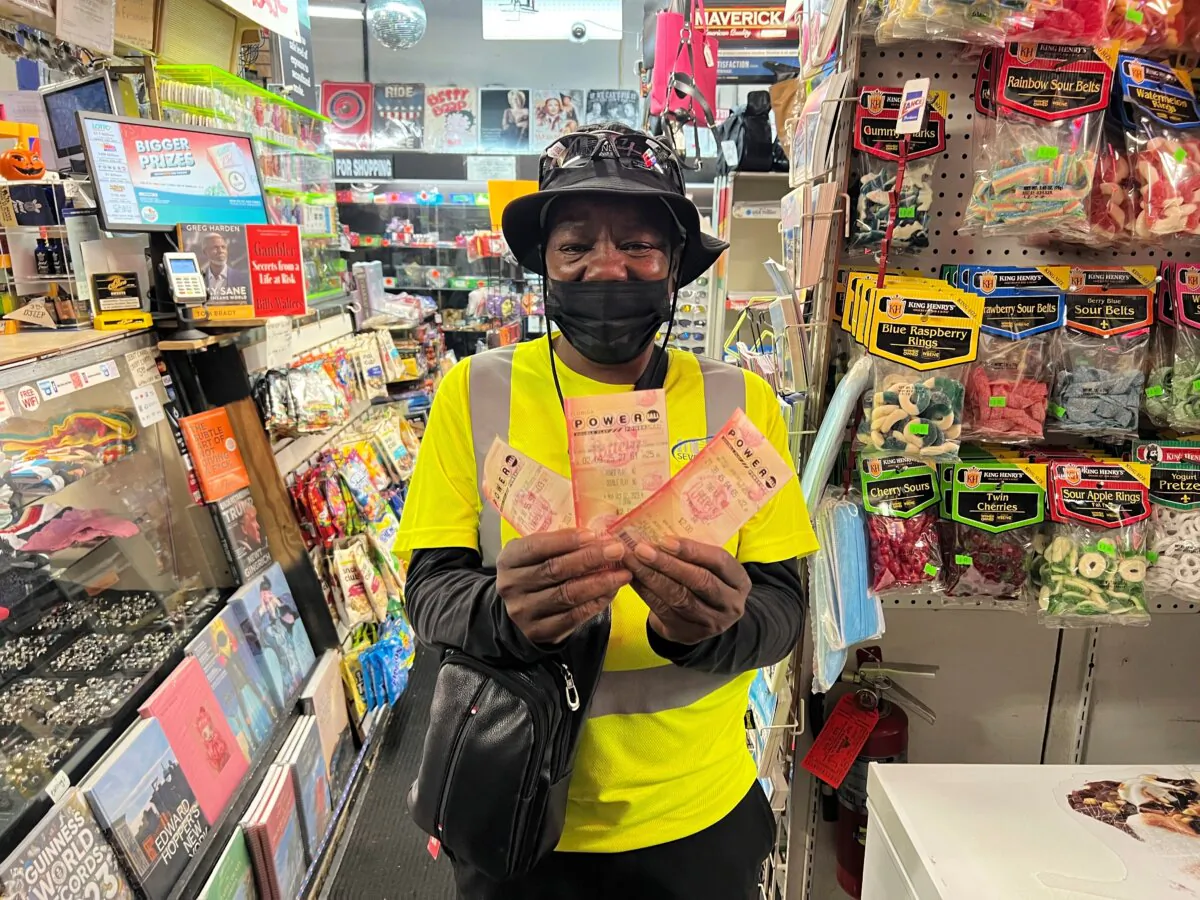 Chevy Johnson, a resident of Broward County, Fla., holds the three Powerball tickets she purchased in the hope of winning the jackpot of over $1 billion, in Fort Lauderdale, Fla., on Oct. 2, 2023. (Daniel Kozin/AP Photo)
