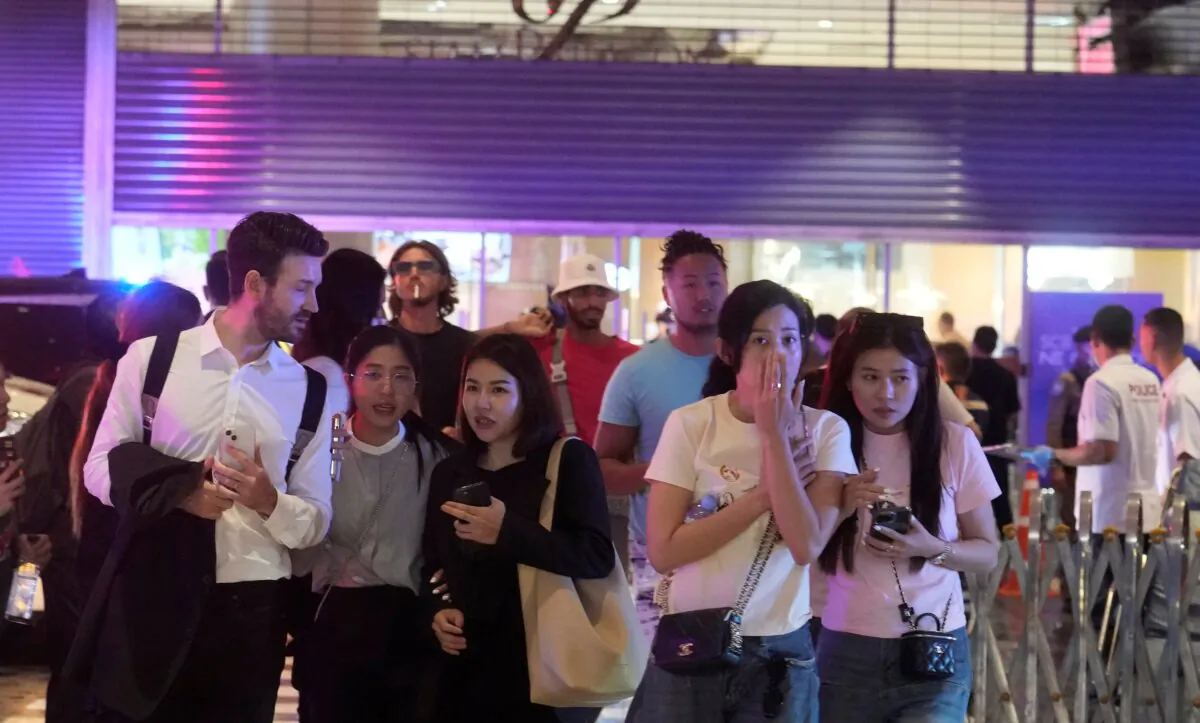 Visitors evacuate from a shopping mall in Bangkok on Oct. 3, 2023. (Sakchai Lalit/AP Photo)