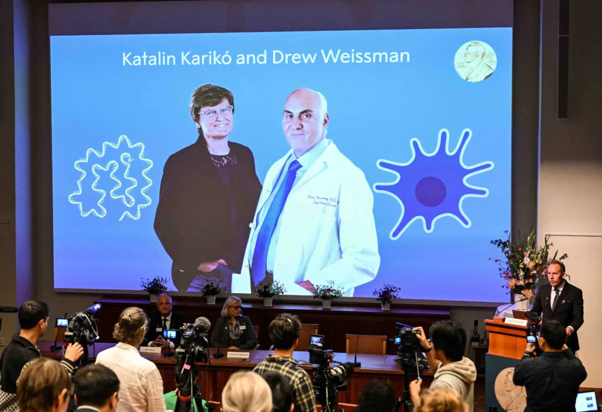 A screen at the Karolinska Institute shows this year's laureates Katalin Kariko of Hungary (L) and Drew Weissman of the U.S. during the announcement of the winners of the 2023 Nobel Prize in Physiology or Medicine at the Karolinska Institute in Stockholm on Oct. 2, 2023. (Jonathan Nackstrand/AFP via Getty Images)