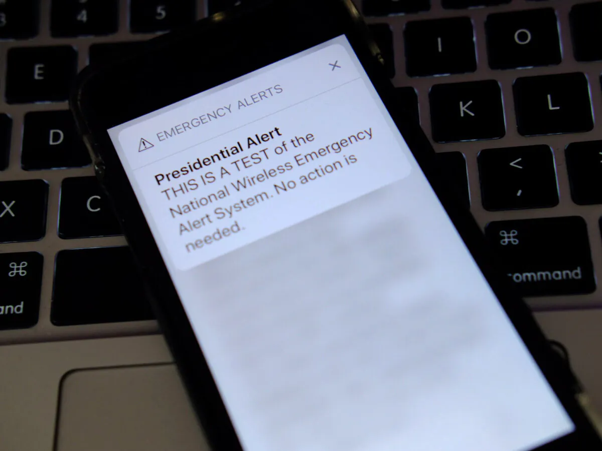 A phone displays an emergency alert message that reads, "THIS IS A TEST of the National Wireless Emergency Alert System. No action is needed," in New York City on Oct. 3, 2018. (Photo Illustration by Theo Wargo/Getty Images)