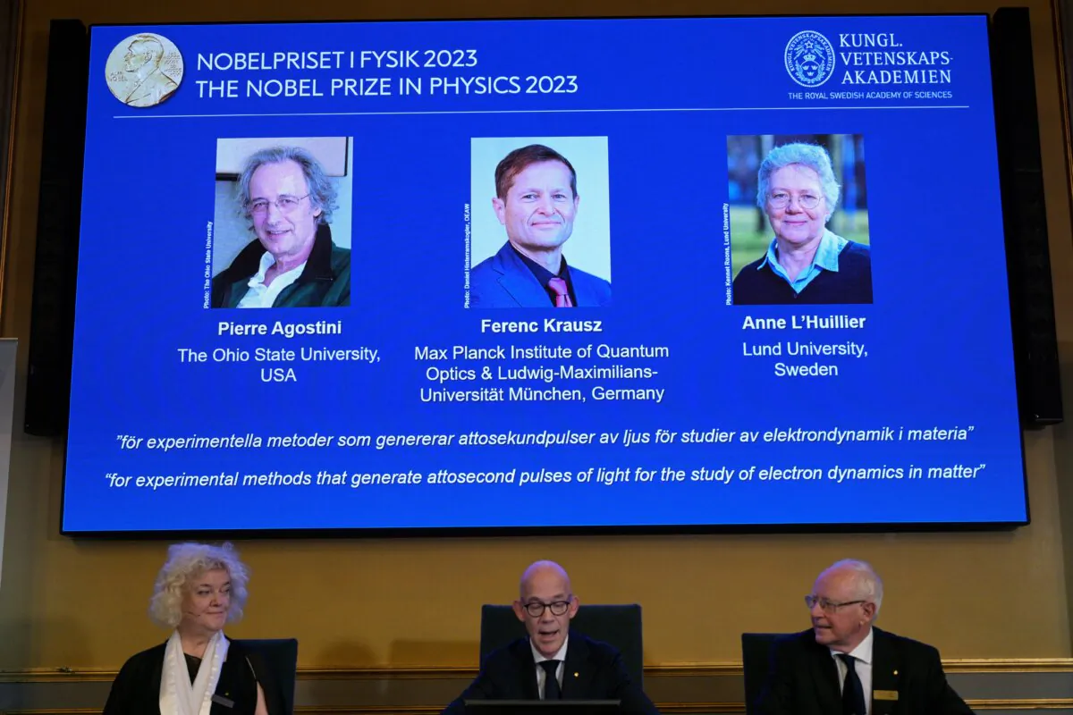 Hans Ellegren, permanent secretary of the Royal Academy of Sciences, flanked by Eva Olsson and Mats Larsson, members, announces this year's Nobel Prize winners in Physics, at the Royal Academy of Sciences in Stockholm, Sweden, on Oct. 3, 2023. (Reuters)