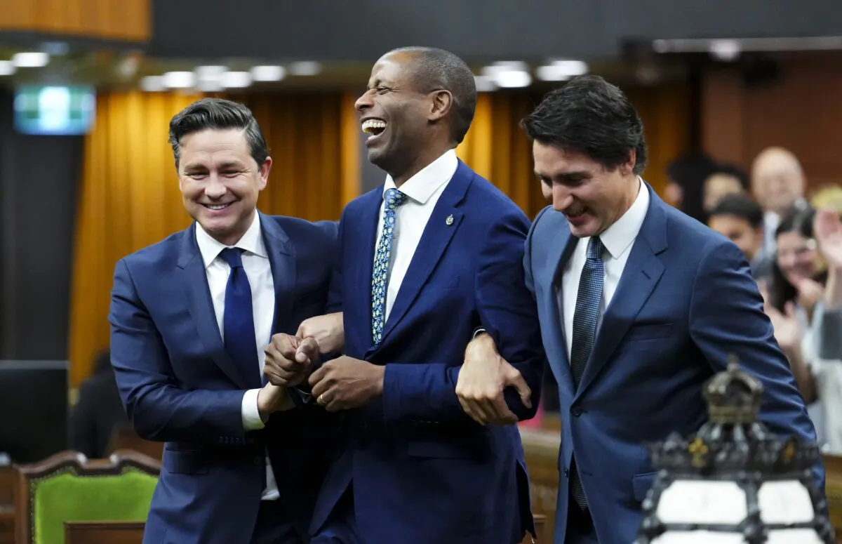 Newly elected Speaker of the House of Commons Greg Fergus is escorted into the House of Commons by Prime Minister Justin Trudeau and Conservative Leader Pierre Poilievre on Parliament Hill in Ottawa on Oct. 3, 2023. (The Canadian Press/Sean Kilpatrick)