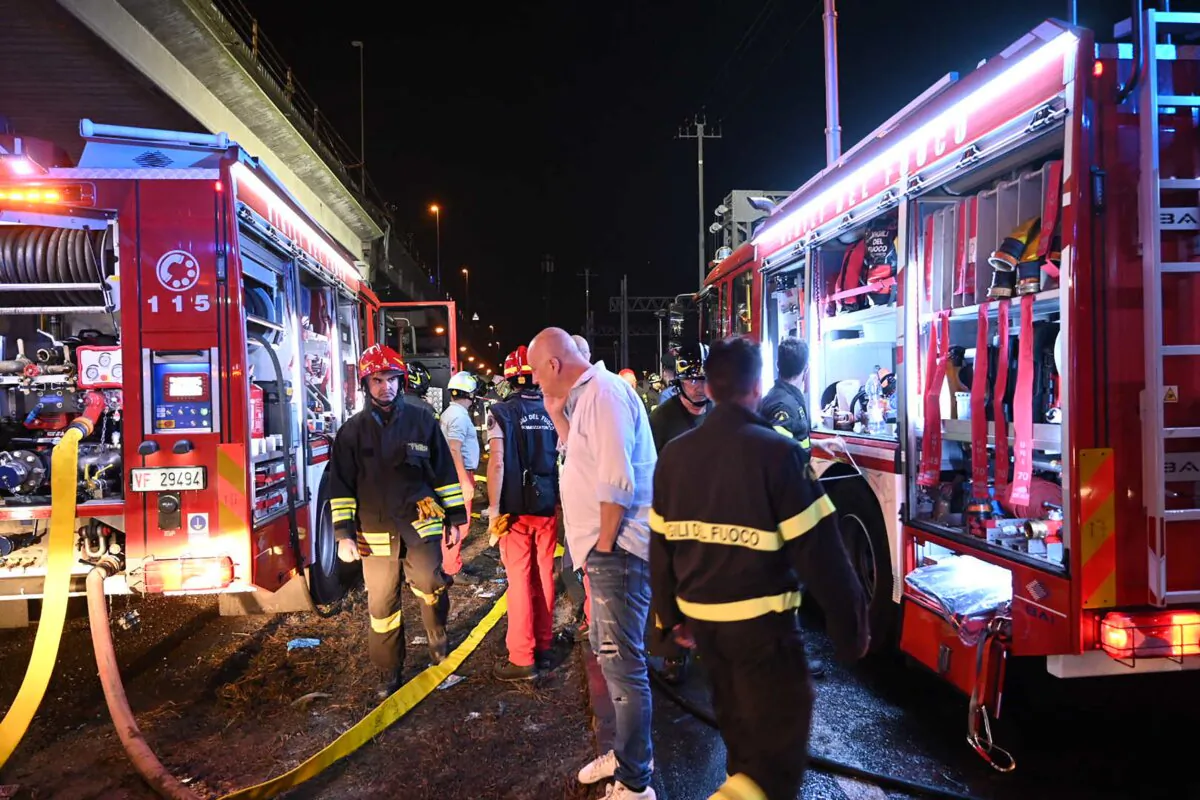 Firefighters work on the site of a bus accident in Mestre, near Venice, on Oct. 3, 2023. (Marco Sabadin/AFP via Getty Images)