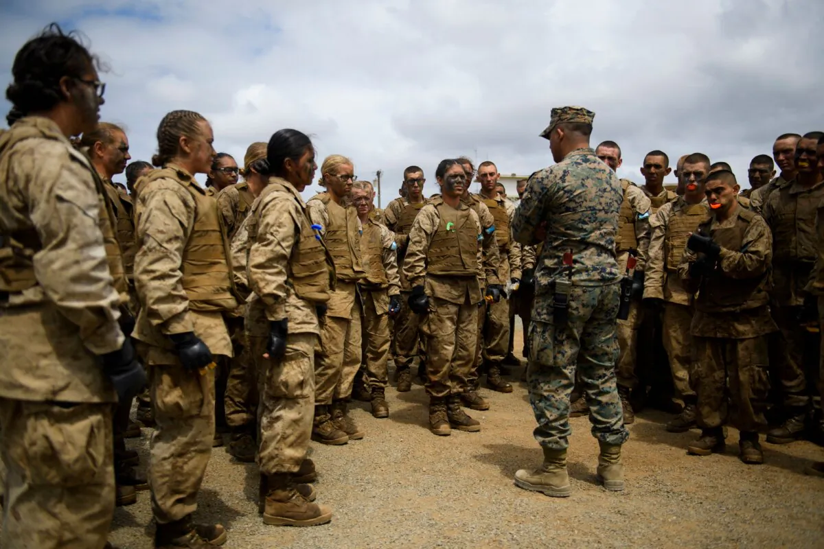 United States Marine Corps (USMC) recruits from Lima Company, the first gender integrated training class in San Diego, receiving a safety briefing before body boxing during The Crucible, the final part of phase three of recruit training before officially becoming U.S. Marines at Camp Pendleton in San Diego County, Calif., on April 21, 2021. (Patrick T. Fallon/AFP via Getty Images)