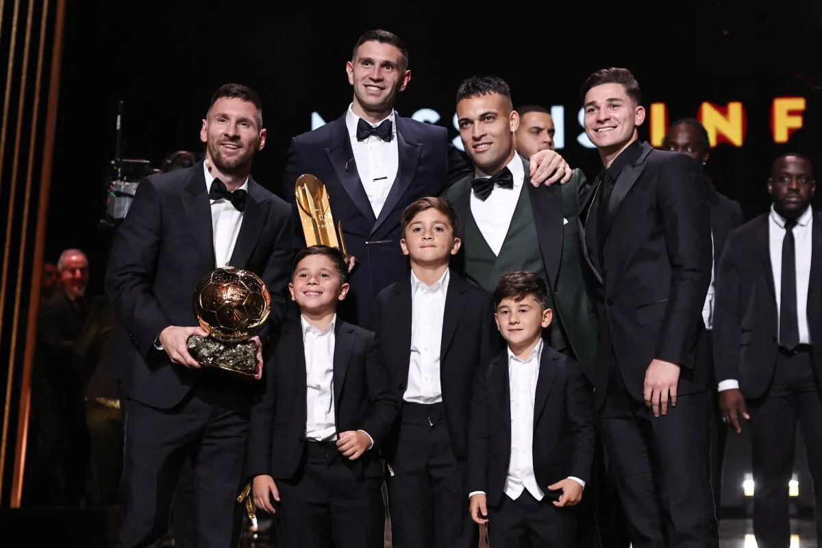 Inter Miami CF's Argentine forward Lionel Messi (L) poses with his trophy and his children (bottom), and with Aston Villa's goalkeeper Emiliano Martinez (Top 2nd L), Inter Milan's Argentine forward Lautaro Martinez and Manchester City's Argentine forward Julian Alvarez during the 2023 Ballon d'Or France Football award ceremony in Paris on Oct. 30, 2023. (Franck Fife/AFP via Getty Images)