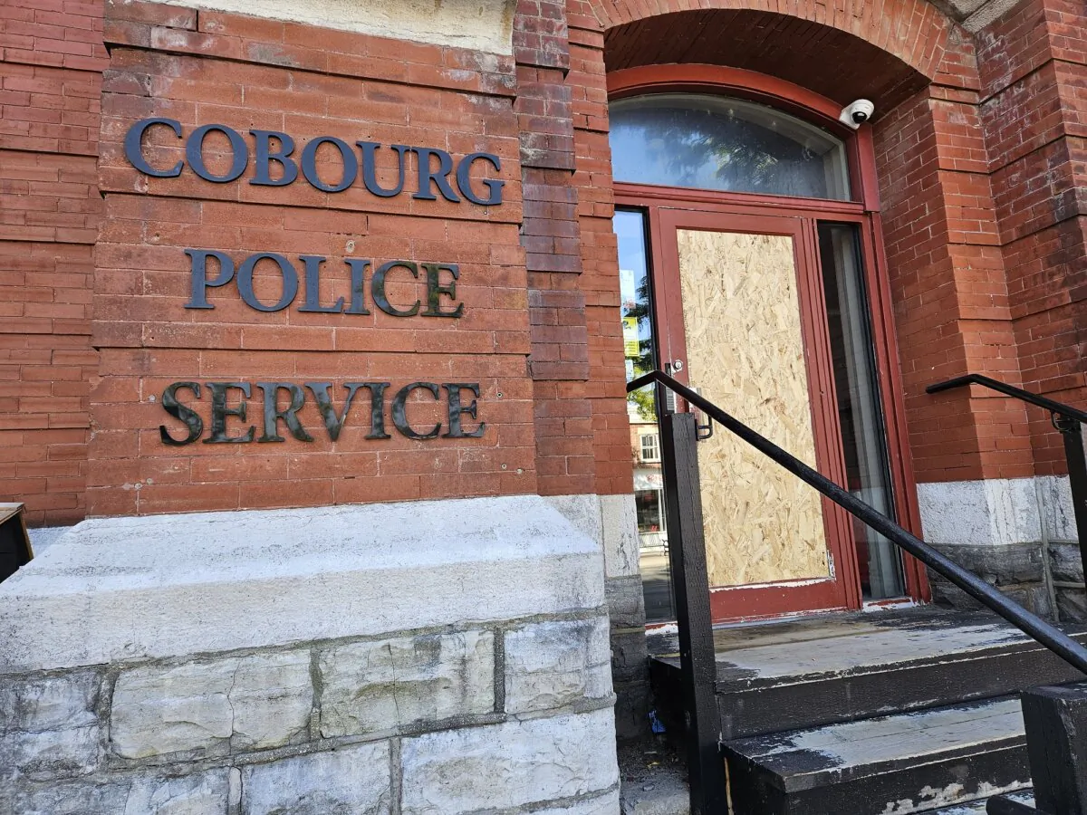 Cobourg Police Service headquarters is seen with a boarded up door on Oct. 2, 2023. (Tara MacIsaac/The Epoch Times)