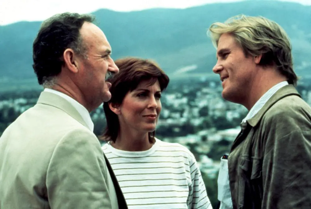 (L–R) Alex Grazier (Gene Hackman), Claire Stryder (Joanna Cassidy), and Russell Price (Nick Nolte), in “Under Fire.” (Orion Pictures)