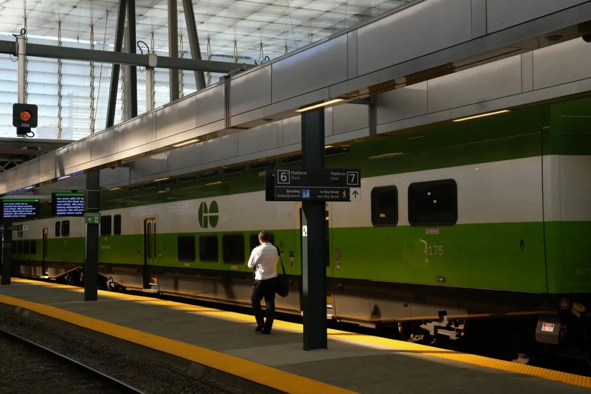A man walks along an empty platform as a train stands idle at Toronto's Union Station after GO Transit and UP Express announced trains are not running on the entire network on Oct. 3, 2023. (The Canadian Press/Chris Young)