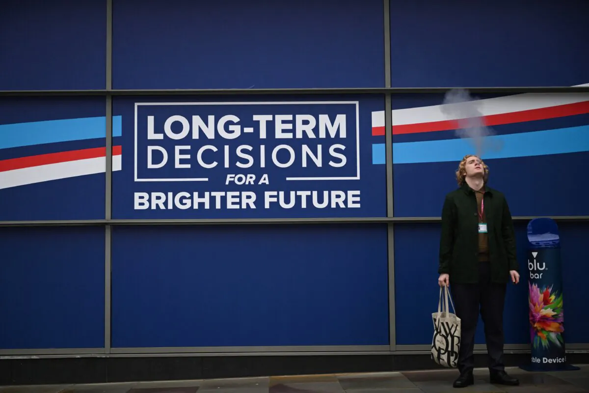 A delegate smokes a cigarette outside the conference centre on the opening day of the annual Conservative Party Conference in Manchester, England, on Oct. 1, 2023. (Justin Tallis/AFP via Getty Images)