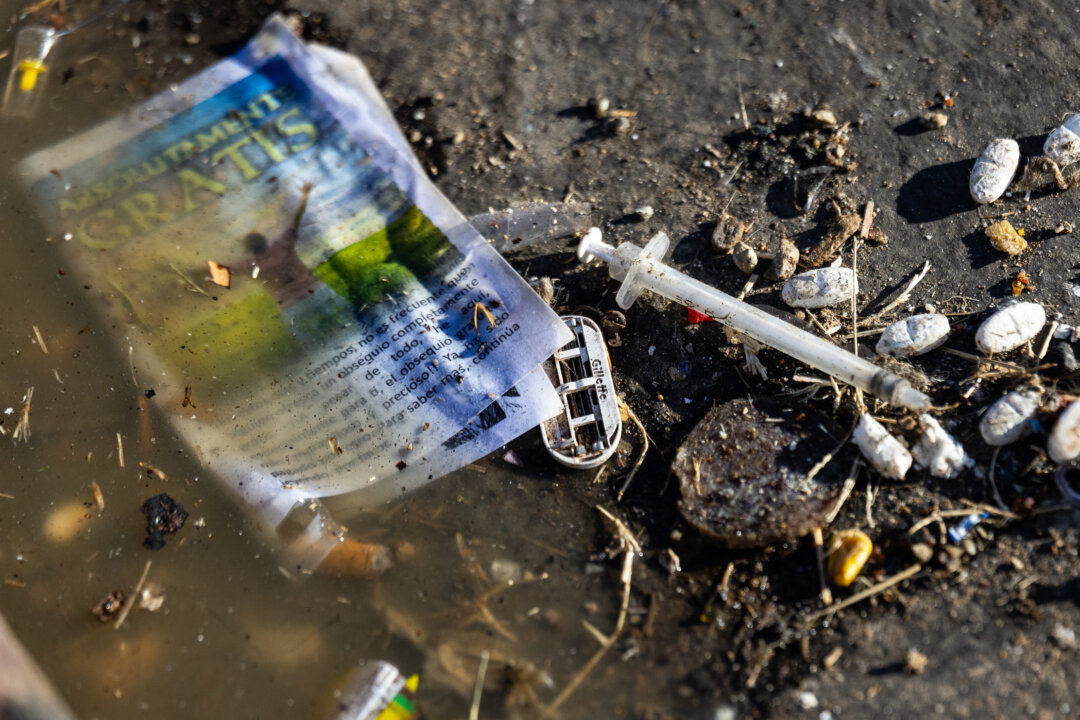 A used syringe sits in a gutter in San Diego, Calif., on Oct. 4, 2023. (John Fredricks/The Epoch Times)