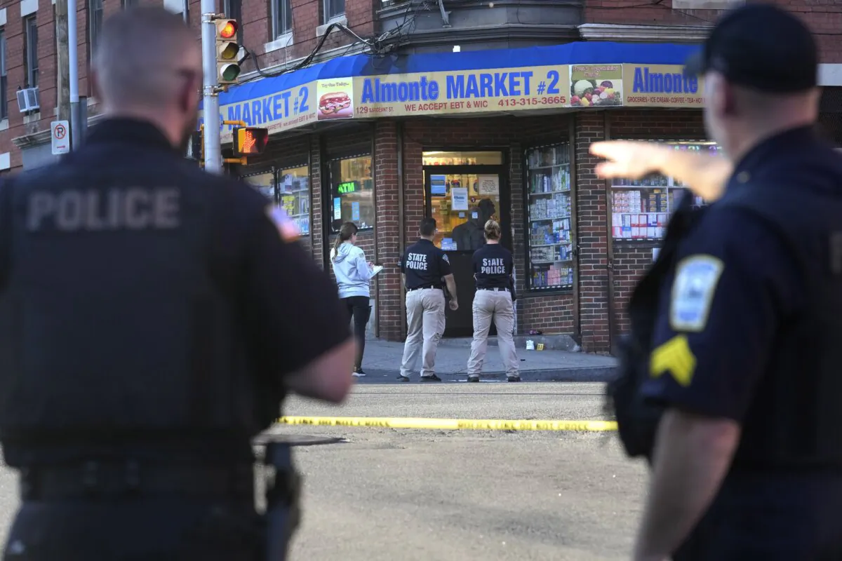 Law enforcement officials investigate the scene where multiple were shot, in Holyoke, Mass., on Oct. 4, 2023. (Steven Senne/AP Photo)
