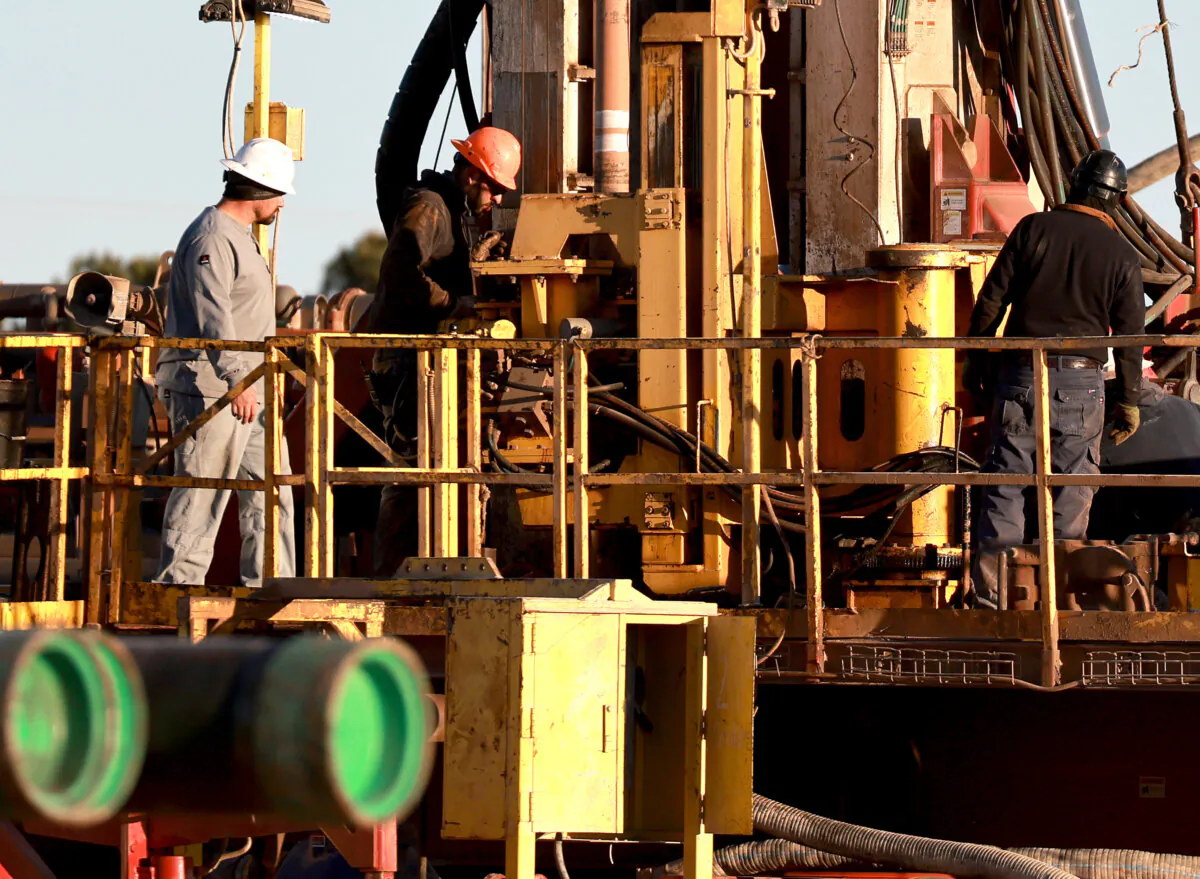 Workers on an oil drilling rig setup in the Permian Basin oil field in Stanton, Texas, on March 12, 2022. (Joe Raedle/Getty Images)