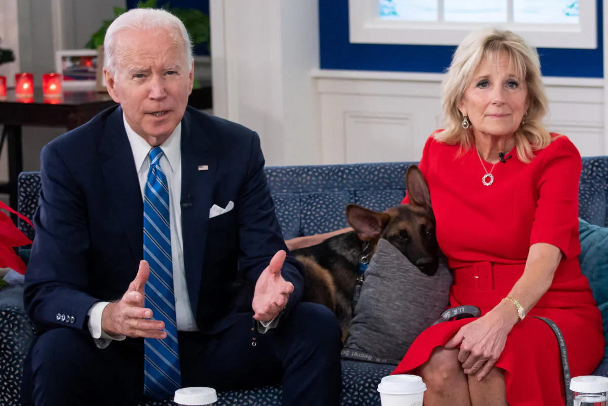 President Joe Biden and First Lady Jill Biden with their new dog, Commander, in the White House in Washington on Dec. 25, 2021. (SAUL LOEB/AFP via Getty Images)