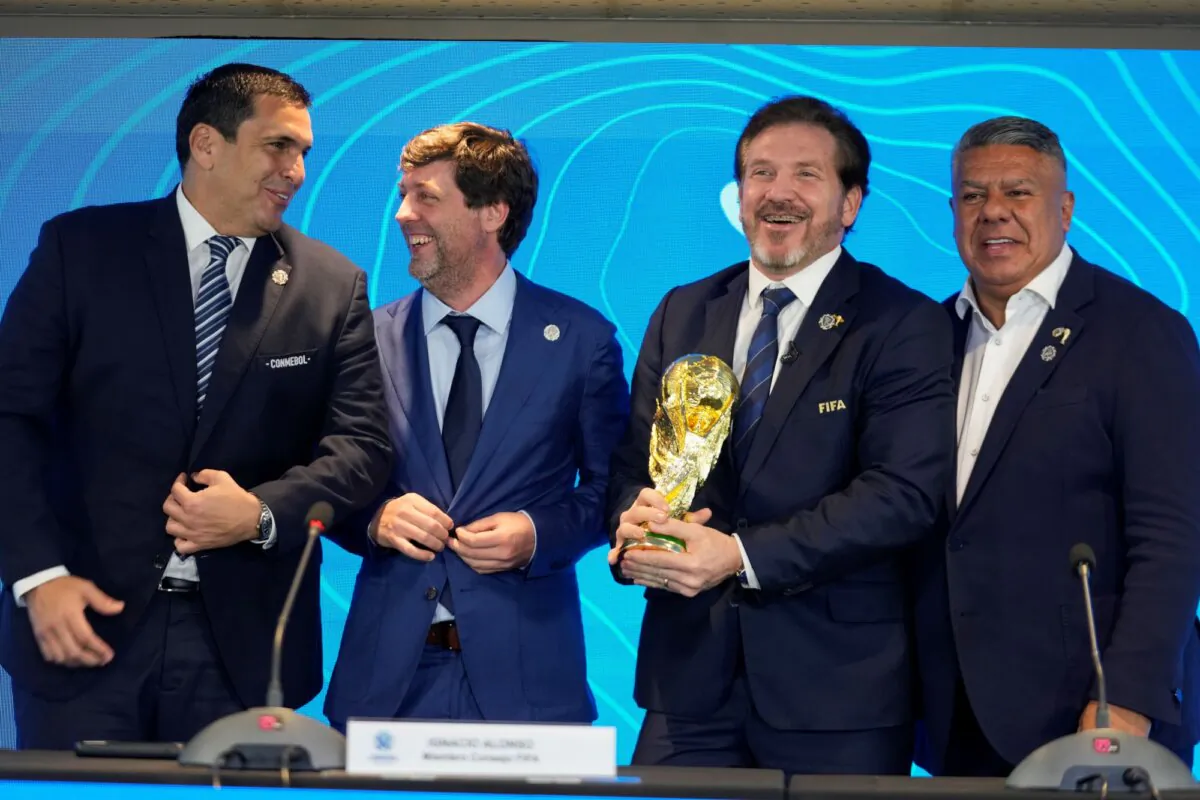 Paraguay's Soccer Association President Robert Harrison, (L), FIFA delegate Ignacio Alonso, (C), Conmebol President Alejandro Dominguez, (3rd L), and Conmebol Vice President Claudio Tapia stand after announcing host countries for the World Cup soccer tournament in Luque, Paraguay, on Oct. 4, 2023. (Jorge Saenz/AP)