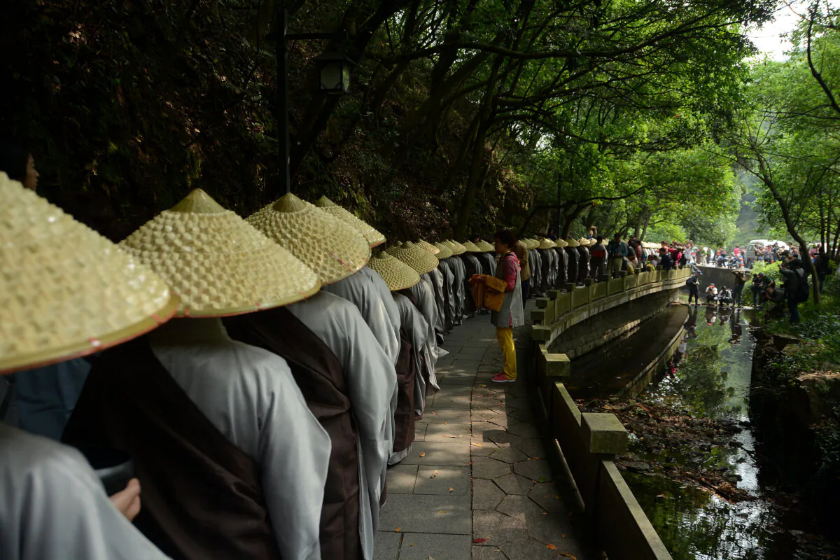 Buddhist monks and nuns of Lingyin Temple walk to receive Buddhists's offerings during a charity event to celebrate the birth of Sakyamuni, founder of Buddhism, in Hangzhou, Zhejiang Province, China, on May 25, 2015. (VCG/VCG via Getty Images)