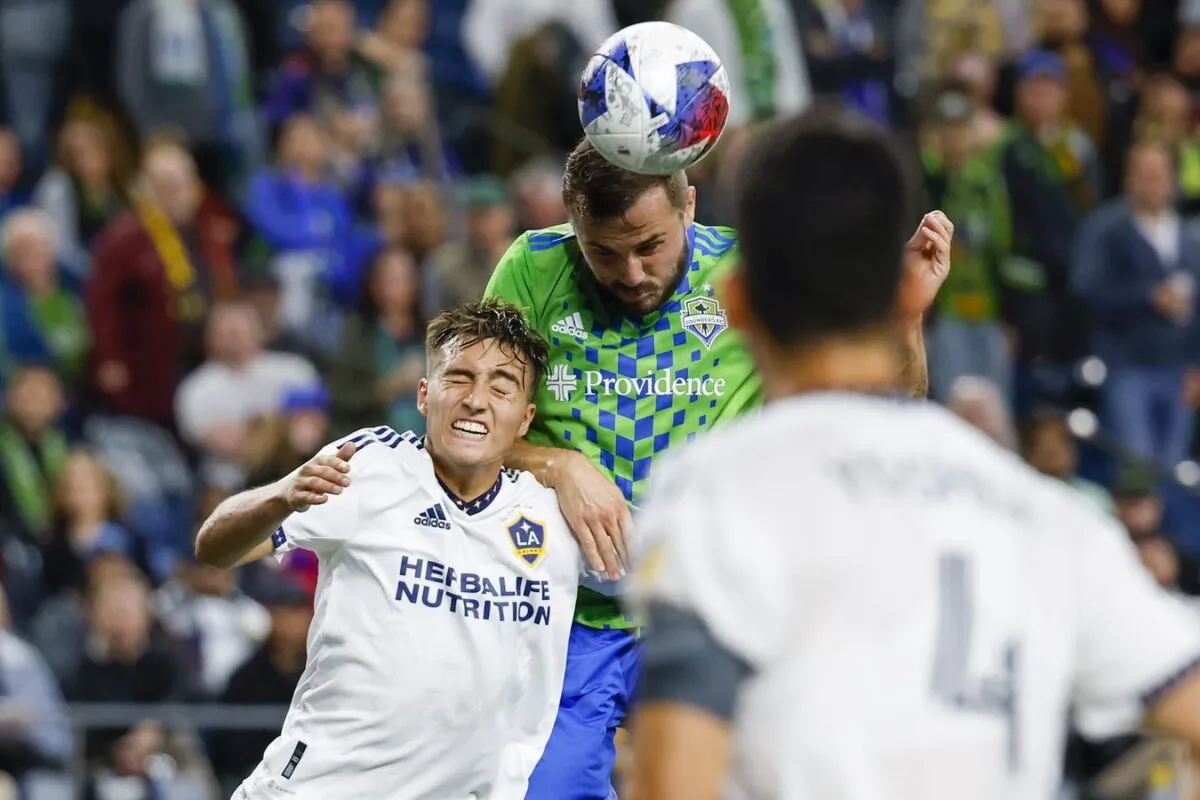 Seattle Sounders FC forward Jordan Morris (13, right) heads a cross against Los Angeles Galaxy defender Julian Aude (3) during the first half at Lumen Field in Seattle on Oct. 4, 2023. (Joe Nicholson/USA TODAY Sports via Field Level Media)