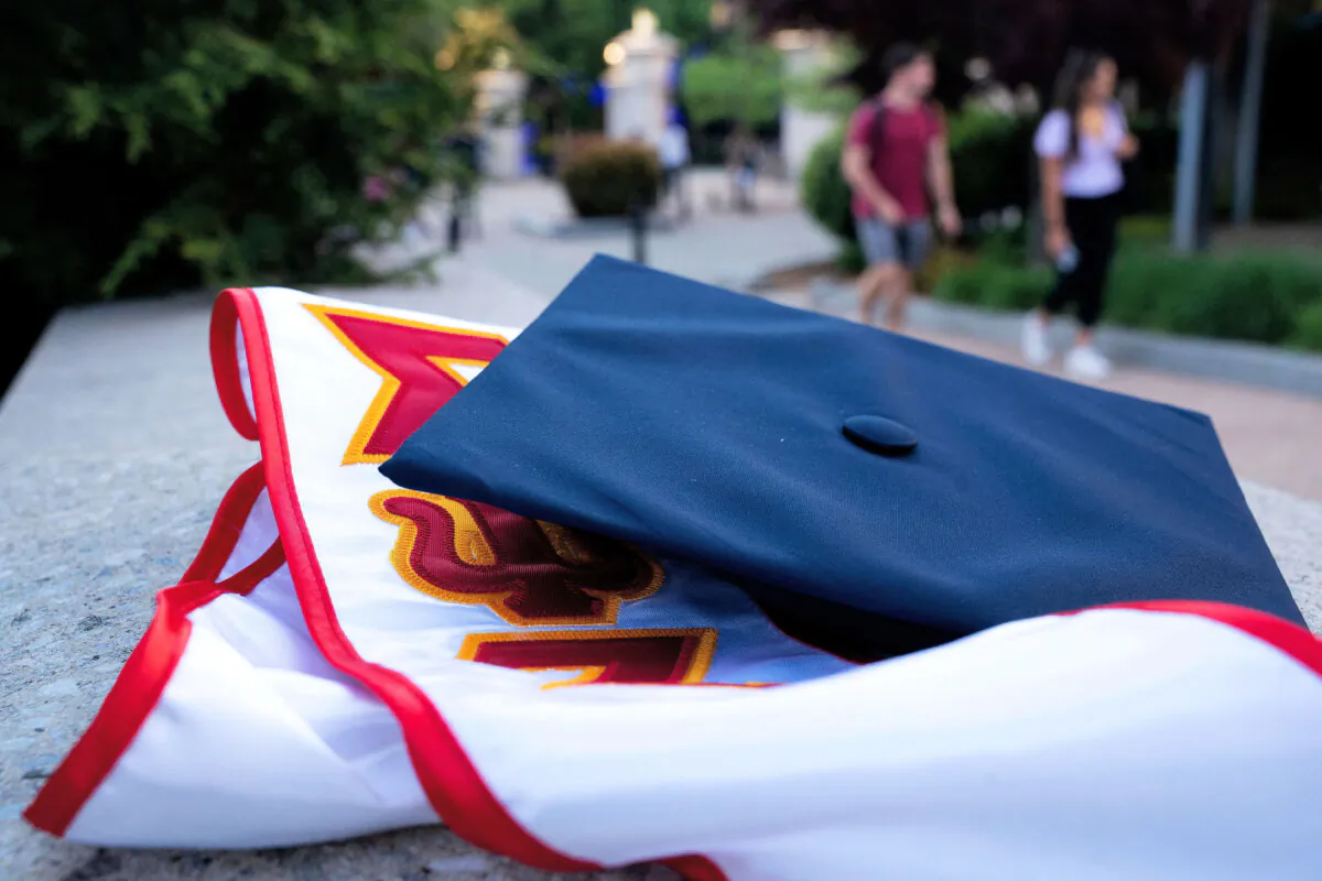 Students walk past a graduation cap and stole at George Washington University in Washington on May 2, 2022. (Stefani Reynolds/AFP via Getty Images)