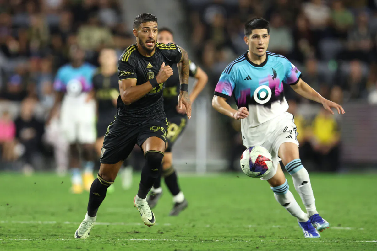 Los Angeles FC forward Denis Bouanga (99) and Minnesota United defender Miguel Tapias (4) race to control the ball at BMO Stadium in Los Angeles, on Oct 4, 2023. (Courtesy of Los Angeles FC via The Epoch Times)