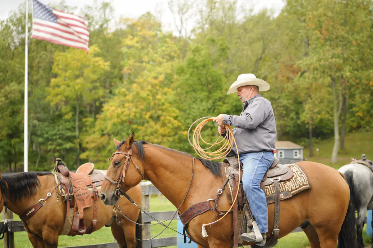 Resident cowboy Greg Maddox demonstrates the roping technique taught at Operation Second Chance in Sabillasville, Md., on Oct. 5, 2023. (Madalina Vasiliu/The Epoch Times)