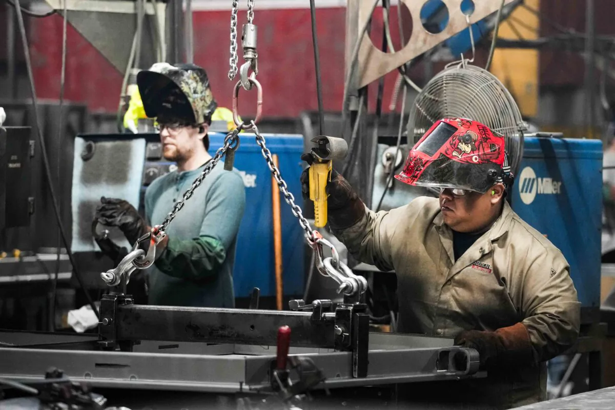 Workers build a door for a safe that is being manufactured at Liberty Safe Company in Payson, Utah, on March 22, 2022.  (George Frey/Getty Images)