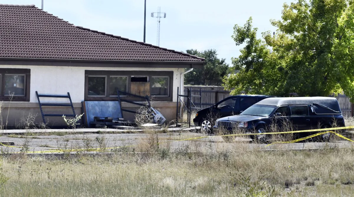 A hearse and debris at the rear of the Return to Nature Funeral Home in Penrose, Colo., on Oct. 5, 2023. (Jerilee Bennett/The Gazette via AP)