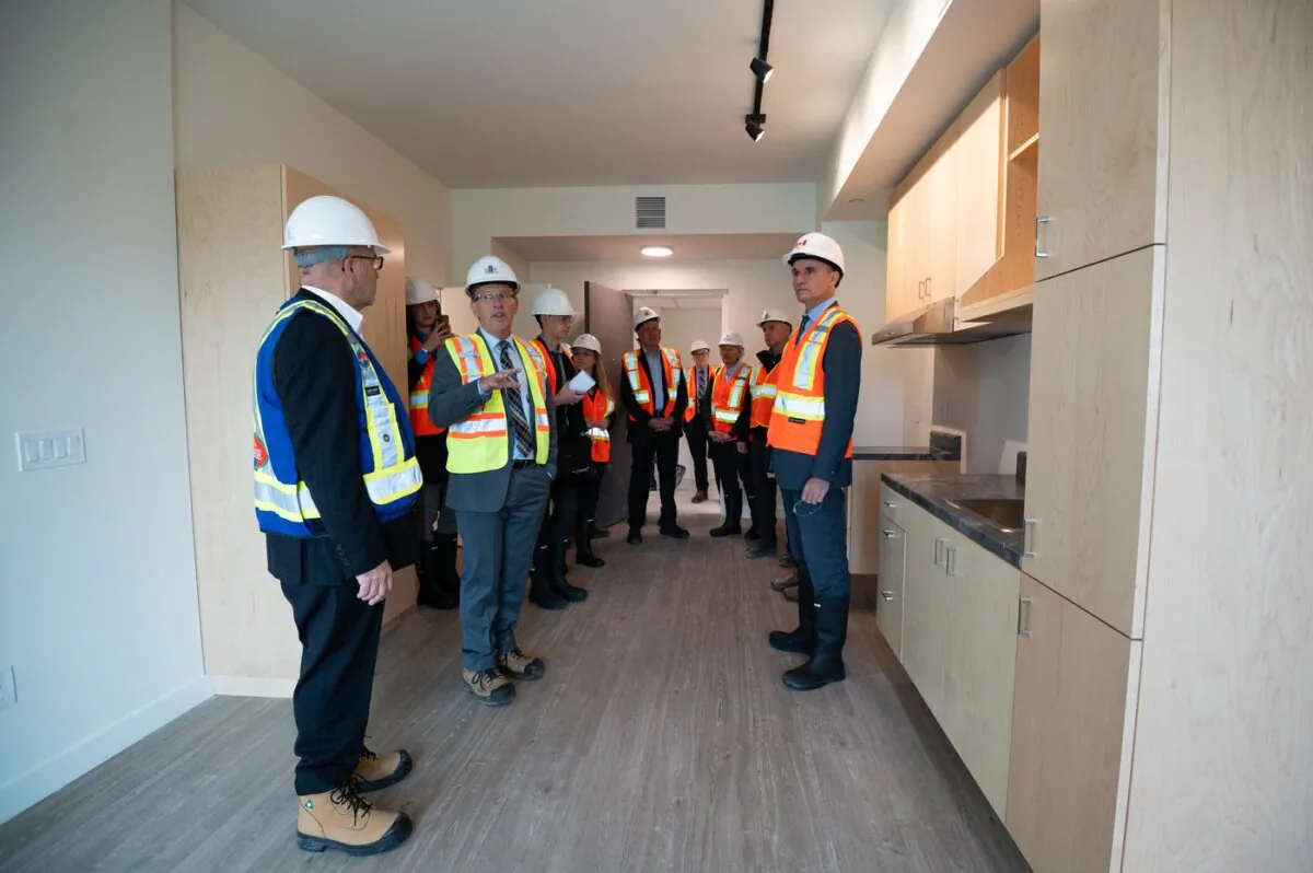 Public Services and Procurement Canada minister Jean-Yves Duclos (R) meets with construction workers at the site of a affordable housing unit managed by Ottawa Community Housing (OCH) during a tour of a series of affordable housing units in Thornecliffe Park region of Ottawa, on Sept. 28, 2023. (The Canadian Press/Spencer Colby)