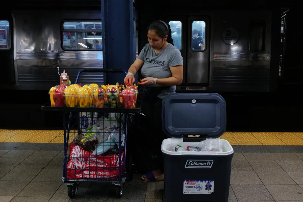 A woman sells candy and other items in a New York City subway station on Aug. 18, 2023. Over 70,000 asylum-seekers have arrived in New York City since last year, according to City Hall, and many have taken to selling items on the streets and subways of the city. (Spencer Platt/Getty Images)