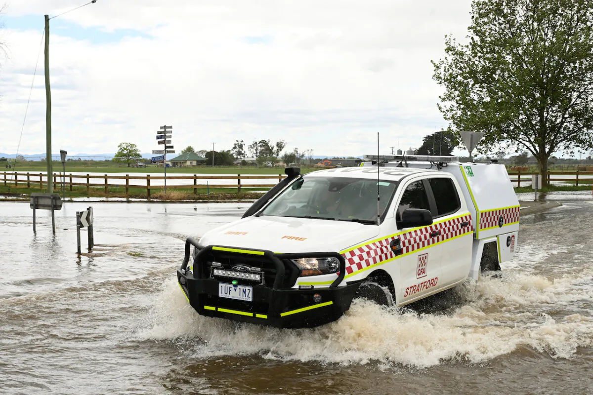 An SES vehicle crosses through flood water in Tinamba in eastern Victoria, Oct. 5, 2023. Victoria's river systems are flooding after days of heavy rain, especially in the east where residents have been told to leave due to increased threat. (AAP Image/James Ross)