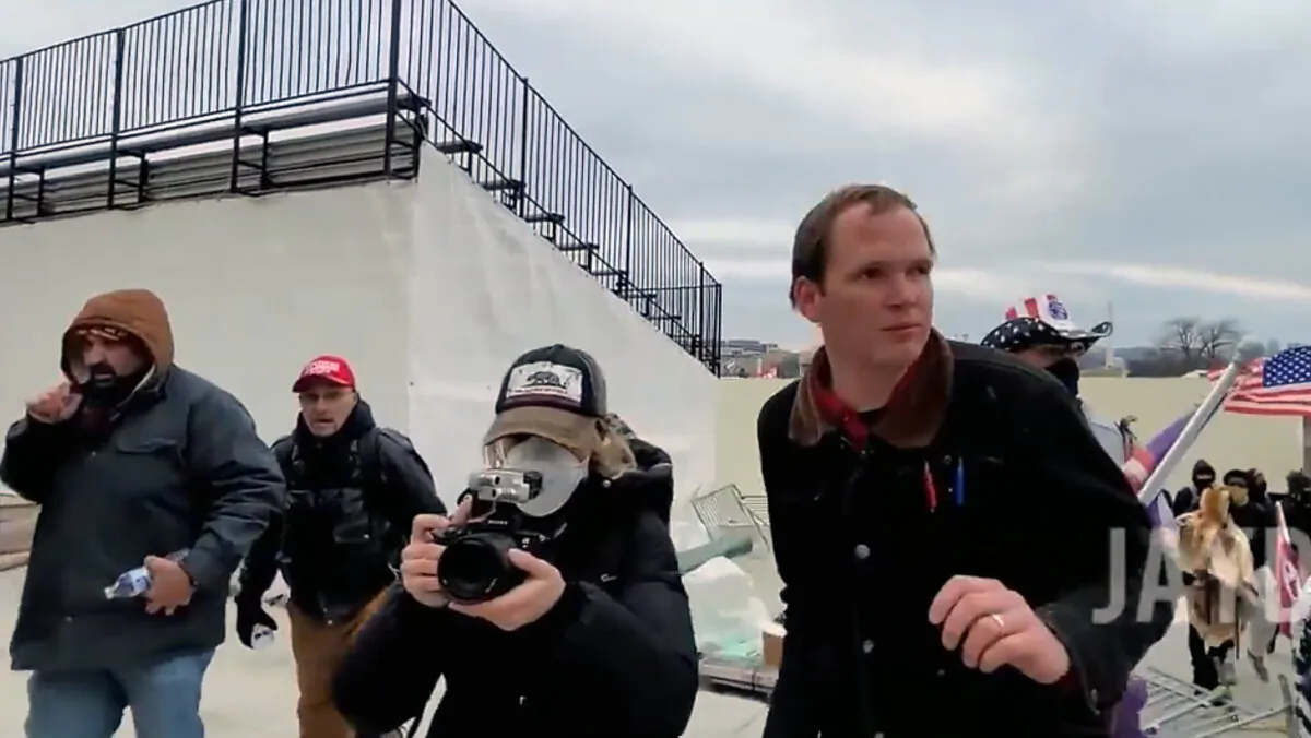 Filmmaker Jade Sacker, 25, of Los Angeles, films activist John Sullivan on the Upper Northwest Terrace of the U.S. Capitol on Jan. 6, 2021. (Jayden X/Screenshot via The Epoch Times)