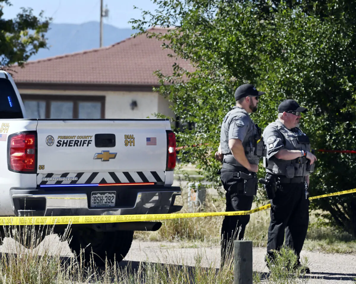 Fremont County deputies guard the road leading to the Return to Nature Funeral Home in Penrose, Colo. Oct. 5, 2023. (Jerilee Bennett/The Gazette via AP)