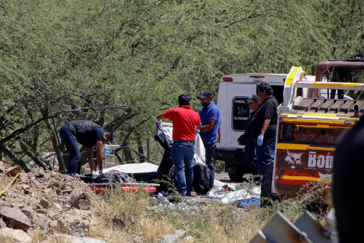 Forensics work over bodies at the scene of a bus accident on the side of the road near Villa de Tepelmeme, Oaxaca state, Mexico, on Oct. 6, 2023. (Nemesio Mendez Jimenez/AP)