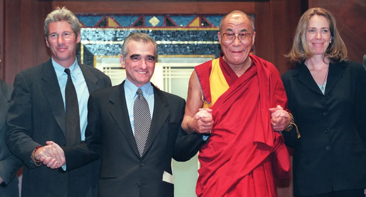 (L-R) Actor Richard Gere, director Martin Scorsese, the Dalai Lama, and producer and screenwriter Melissa Mathison hold hands at the end of a brief meeting with reporters prior to a speech by the Dalai Lama at an awards ceremony in New York on April 30, 1998. The ceremony honored Mr. Scorsese and Ms. Mathison for their work on the film 'Kundun.' (Matt Campbell/AFP via Getty Images)
