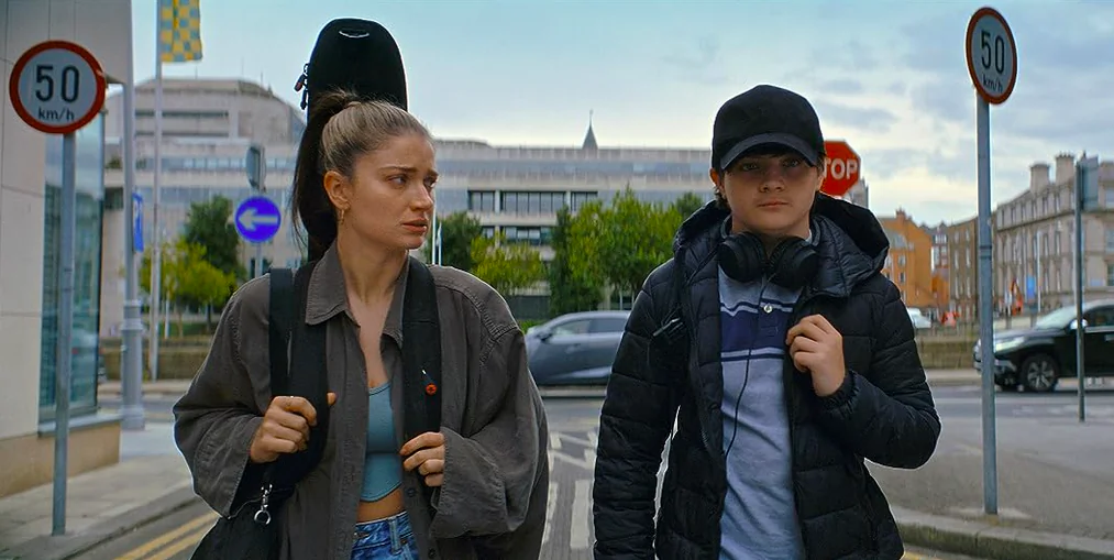 Flora (Eve Hewson) is concerned about her son Max's (Oren Kinlan) schoolboy crush on a girl out of his league in “Flora and Son.” (Apple TV+)
