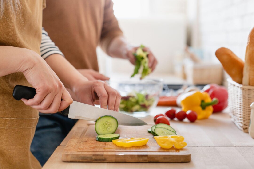Properly cleaning the cutting board before and after use can help prevent food from being contaminated with bacteria or fungal toxins. (Inside Creative House/Shutterstock)