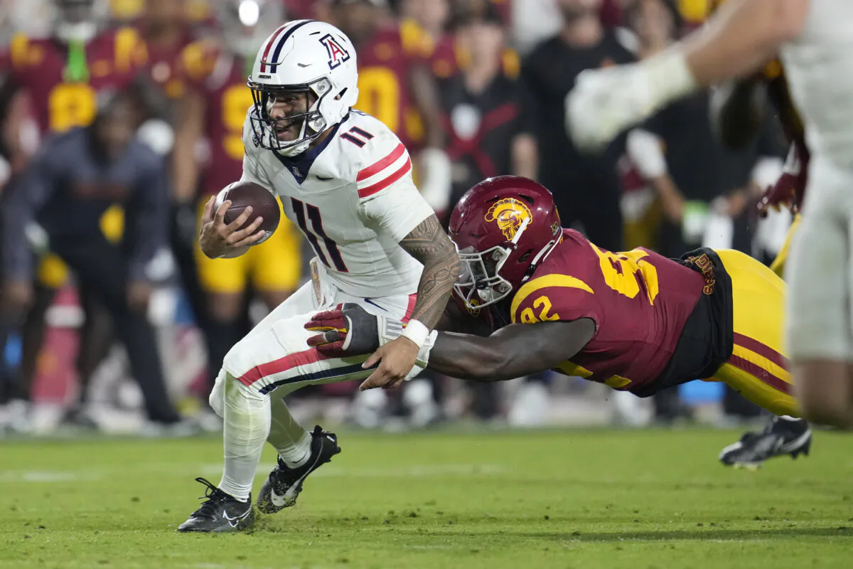Arizona quarterback Noah Fifita (11) is tackled by Southern California defensive lineman Kyon Barrs (92) during the second half of an NCAA college football game in Los Angeles on Oct. 7, 2023. (Marcio Jose Sanchez/AP Photo)