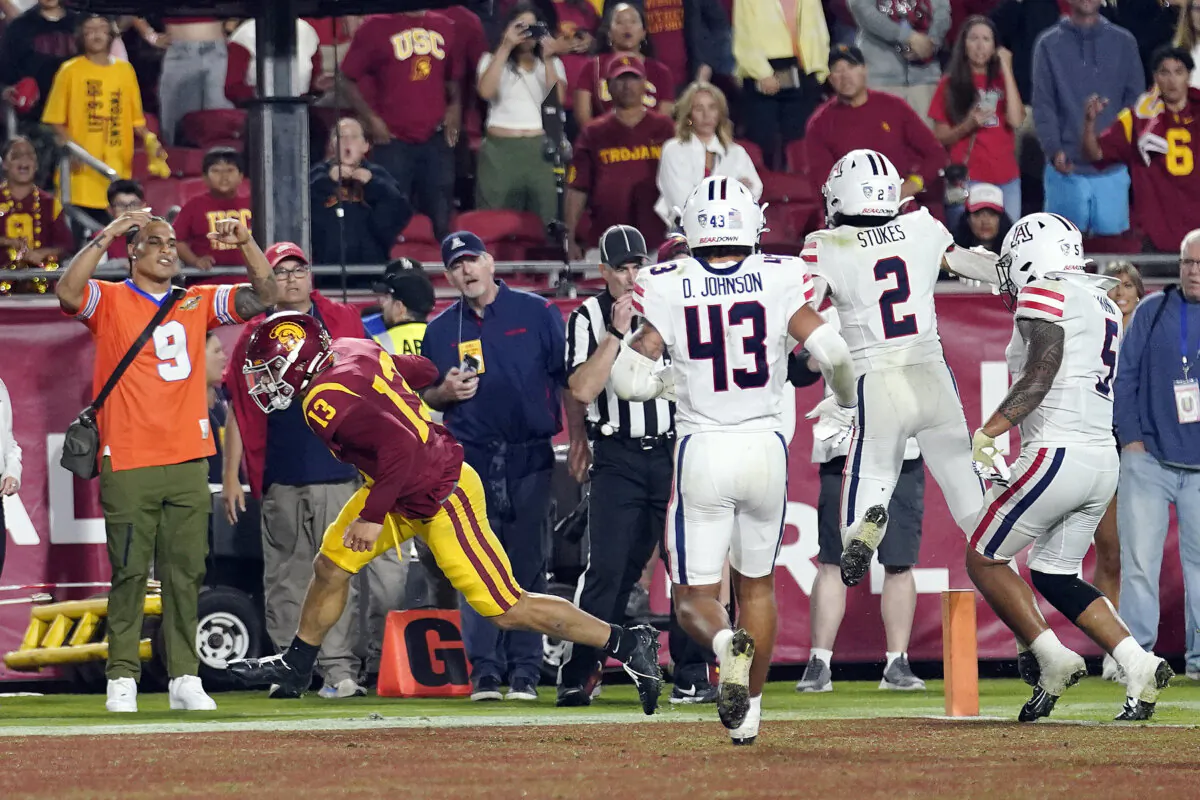 Southern California quarterback Caleb Williams (No. 13) scores a two-point conversion to give Southern California the lead during overtime of an NCAA college football game against Arizona in Los Angeles on Oct. 7, 2023. (Marcio Jose Sanchez/AP Photo)