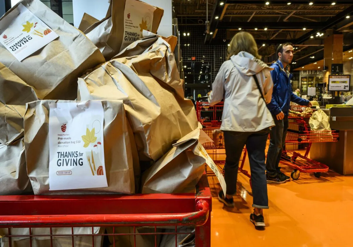 A cart is filled with pre-filled bags of food, during a Thanksgiving food drive for the Ottawa Food Bank at a grocery store in Ottawa, on Oct. 7, 2023. (The Canadian Press/Justin Tang)