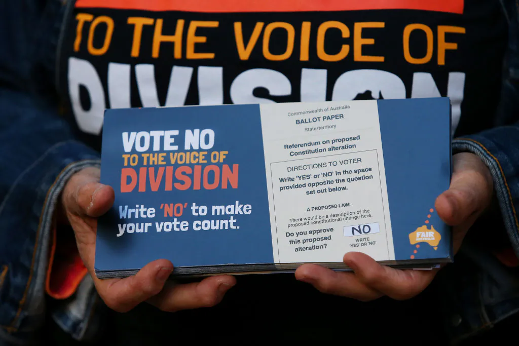 A campaigner holds a “How to vote No” pamphlet outside a polling centre in the central business district in Sydney, Australia, on Oct. 9, 2023. (Lisa Maree Williams/Getty Images)