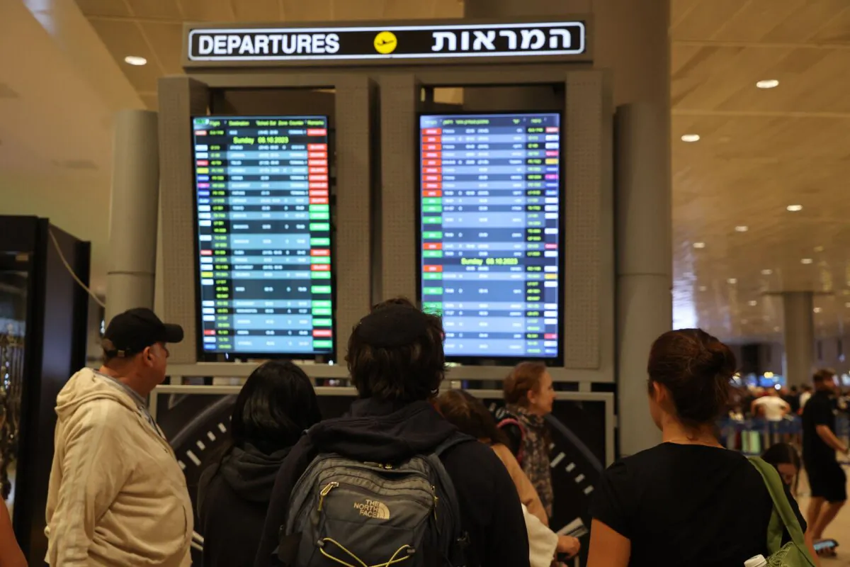 Passengers look at a departure board at Ben Gurion Airport near Tel Aviv, Israel, on Oct. 7, 2023, as flights are canceled because of the Hamas surprise attacks. (Gil Cohen-Magen/AFP via Getty Images)